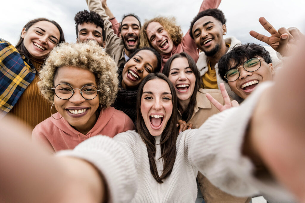 Friends taking big group selfie shot celebrating being Together